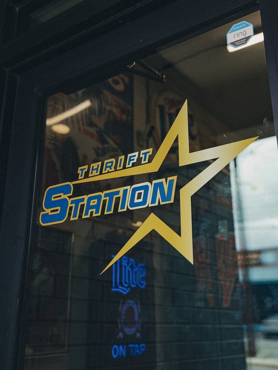 The Thrift Station star logo on the shop's glass door