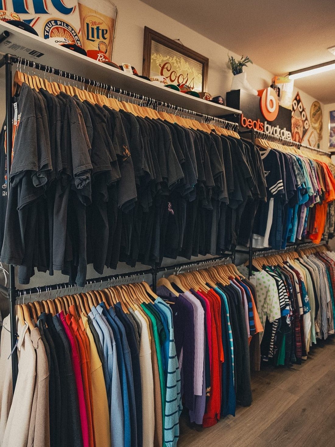 Racks of vintage tees under Miller Lite and Coors signs